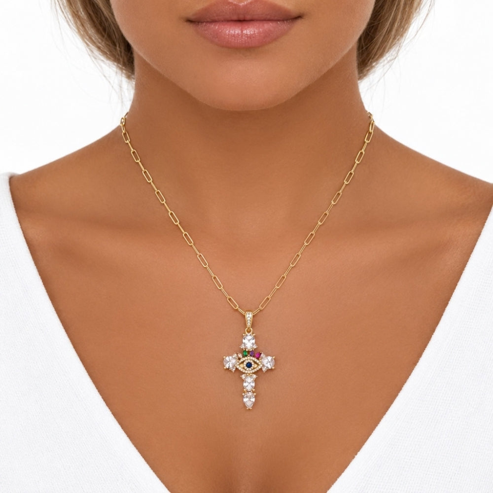 Front view of a model wearing the gold-tone evil eye cross necklace, showing the chain length and pendant placement.