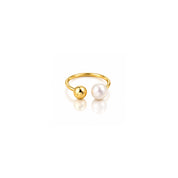 A gold-plated open ring featuring two spherical beads, one polished gold and one white freshwater pearl, displayed on a clean white background with a soft reflection.