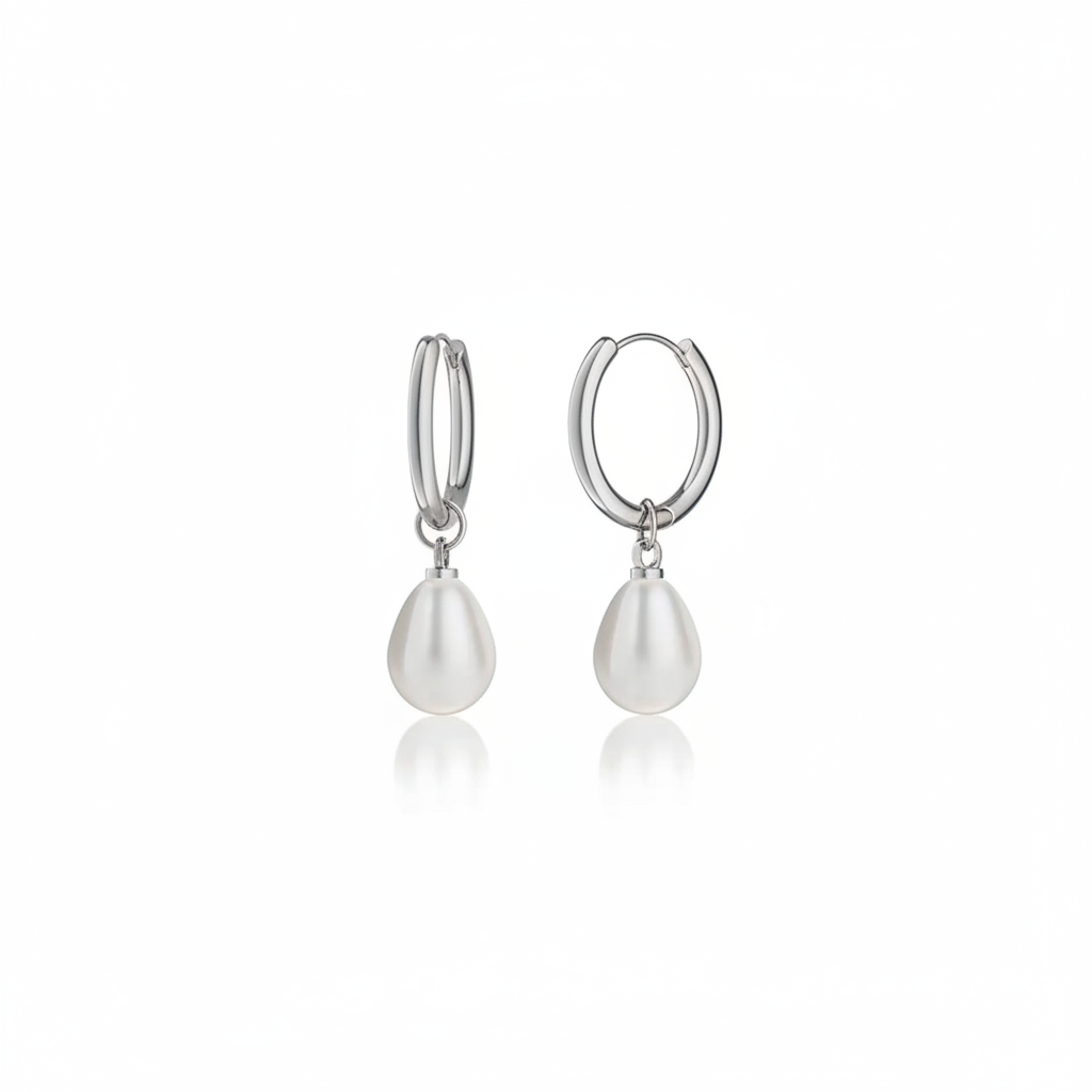 A pair of silver hoop earrings with teardrop-shaped white freshwater pearls hanging from the hoops, shown against a plain white background with a soft reflection below.
