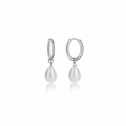 A pair of silver hoop earrings with teardrop-shaped white freshwater pearls hanging from the hoops, shown against a plain white background with a soft reflection below.