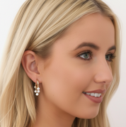Woman modelling Diamond Dangle Huggie Earrings