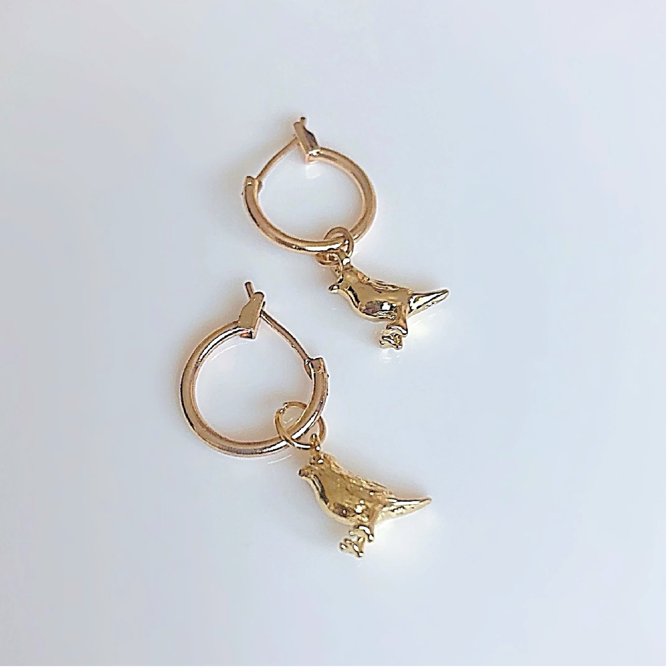 Gold bird charm earrings 